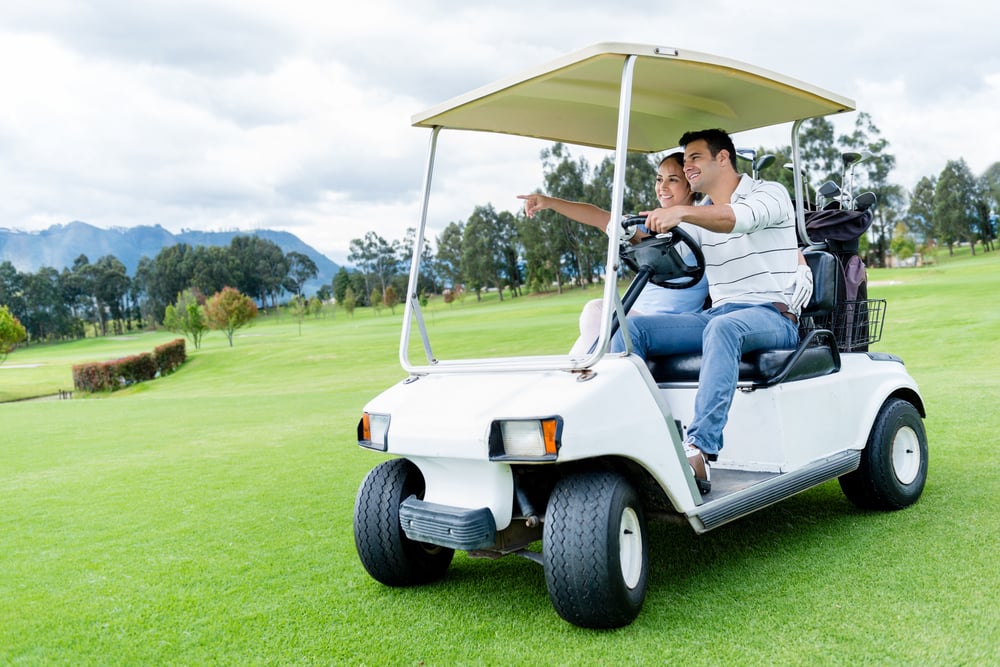 Group of players in a golf cart at the course