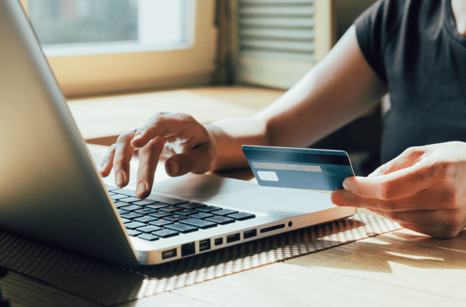 man using laptop and credit card 