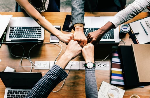 office team fist bumping