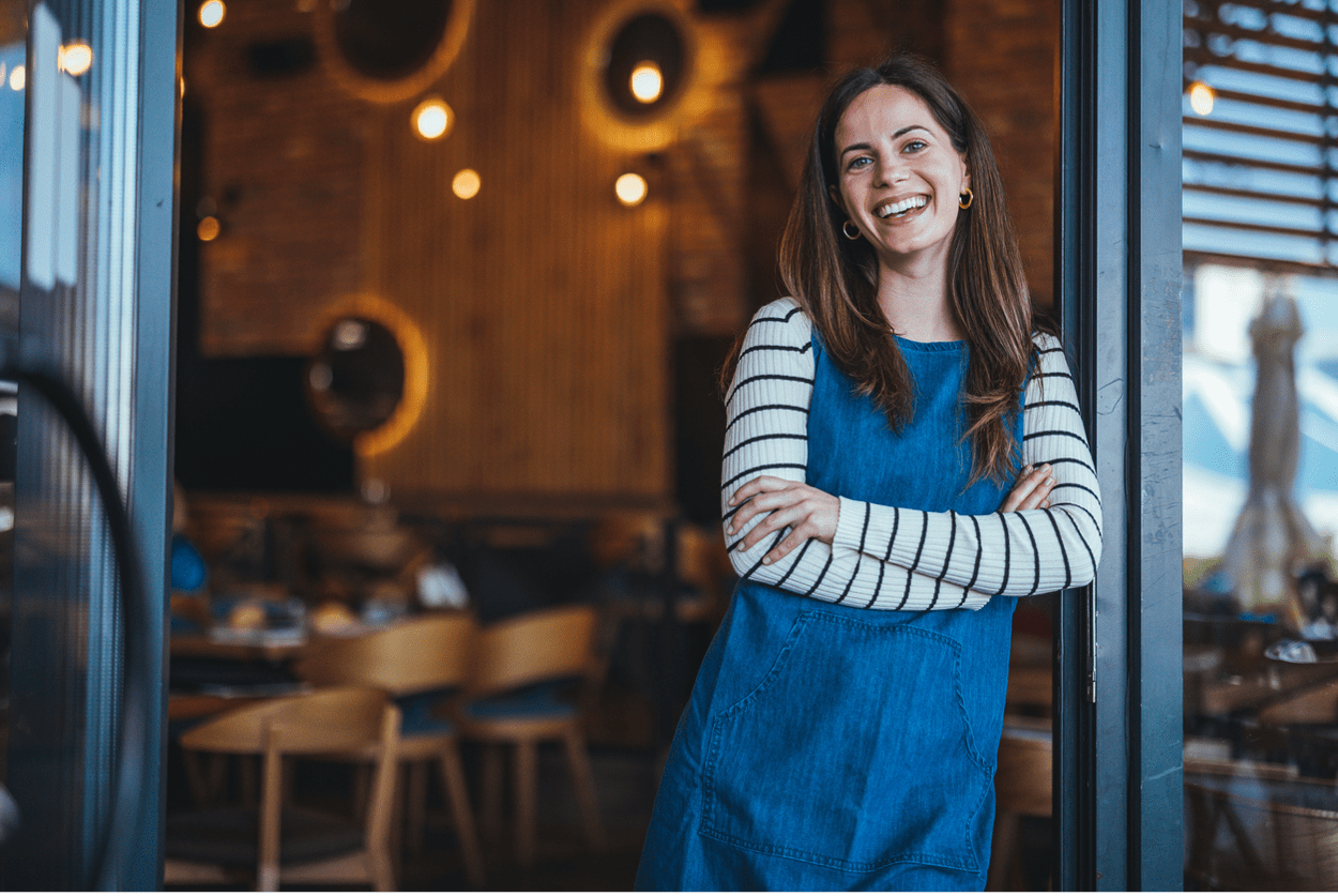 happy woman in front of restaurant compressed